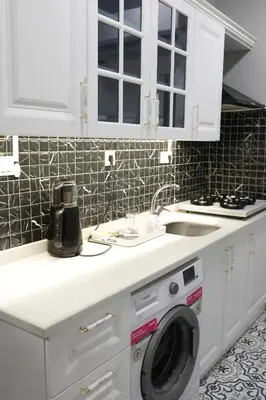 a kitchen with a washing machine and a sink at Tavra Daltaban in Istanbul