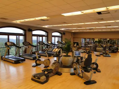 a gym with a lot of treadmills and exercise bikes at Kemer Country Hotel İstanbul in Istanbul