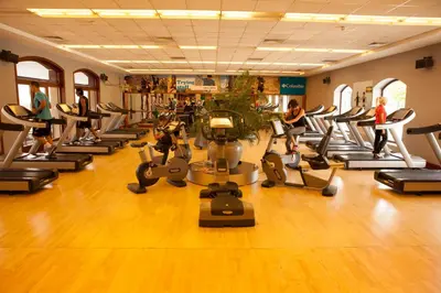 a gym with a lot of treadms and elliptical machines at Kemer Country Hotel İstanbul in Istanbul