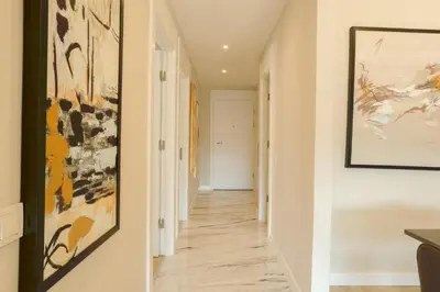 a hallway with white walls and art on the walls at Sense Suite Residence-15 in Istanbul