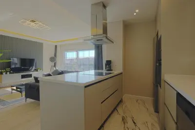 a kitchen with a counter top and a living room at Sense Suite Residence-15 in Istanbul