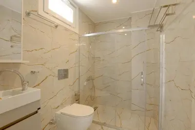 a bathroom with a shower and a toilet and a sink at Sense Suite Residence-15 in Istanbul