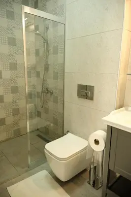 a bathroom with a shower and a toilet and a sink at Lighthouse in Istanbul