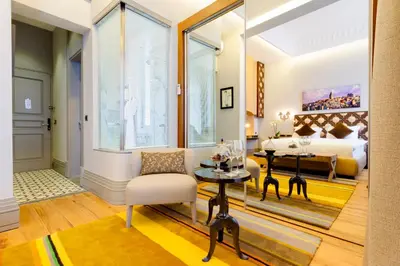 a bedroom with a bed and a table and a chair at Ravouna 1906 Bosphorus Istanbul in Istanbul