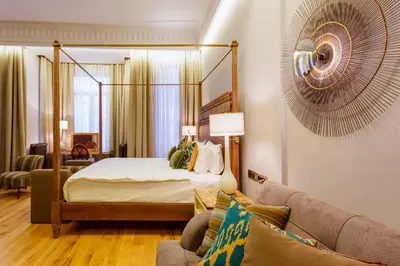 a bedroom with a bed and a living room at Ravouna 1906 Bosphorus Istanbul in Istanbul