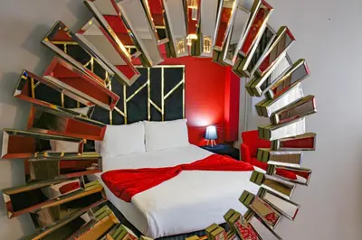 a bedroom with a bed in a room with bookshelves at Green Moringa Termal Hotel in Termal