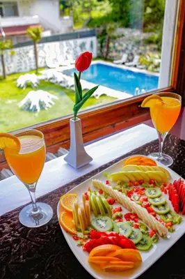 a plate of food and two glasses of orange juice at Green Moringa Termal Hotel in Termal