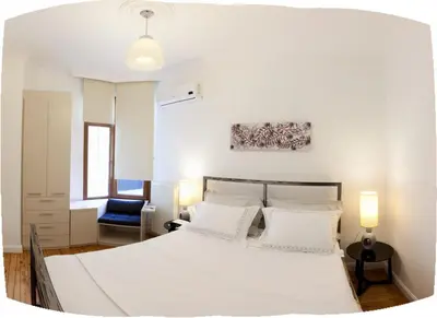 a bedroom with a large white bed with two pillows at Bomonti Residence 3 bedroom duplex in Istanbul