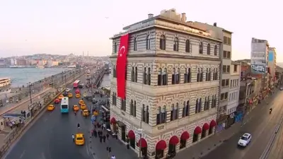 a building with a red sign on the side of a street at Nordstern Hotel Galata in Istanbul