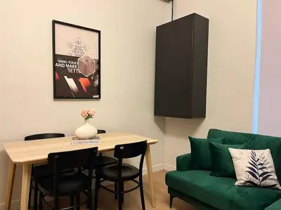 a living room with a table and a green couch at Charming 2BR AC in Center - Santur D1 in Istanbul
