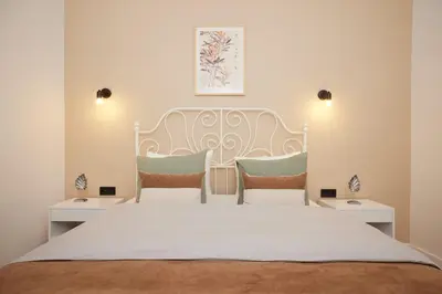 a bedroom with a large white bed with two chairs at Charming 3BR 2Bath AC in Center - Santur D2 in Istanbul