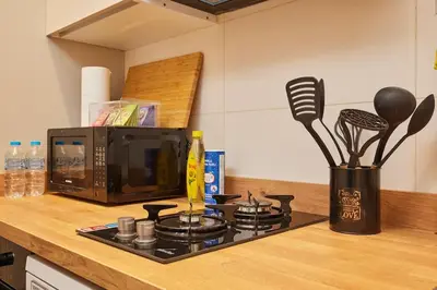 a kitchen counter with a stove and a microwave at Stunning 3BR 2Bath AC in Center - SanturD4 in Istanbul