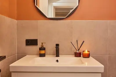 a bathroom sink with a mirror and a candle at Stunning 3BR 2Bath AC in Center - SanturD4 in Istanbul