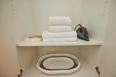a bathroom with a toilet and towels on a shelf at Stunning 3BR 2Bath AC in Center - SanturD4 in Istanbul