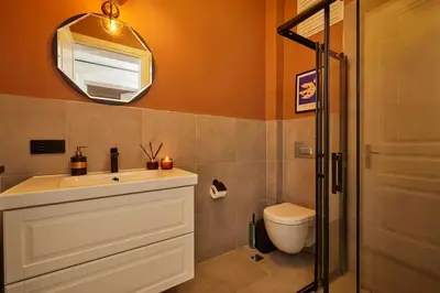 a bathroom with a sink and a mirror and a toilet at Stunning 3BR 2Bath AC in Center - SanturD4 in Istanbul