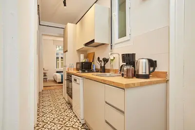a kitchen with white cabinets and a counter top at Stunning 3BR 2Bath AC in Center - SanturD4 in Istanbul