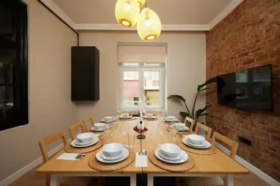a dining room with a wooden table with chairs at Spacious 6BR 3Bath AC in Center - Santur D5-6 in Istanbul