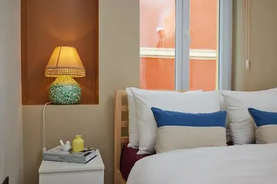 a bedroom with a bed with a lamp on a night stand at Charming 3BR 2Bath AC in Center - Santur D7 in Istanbul