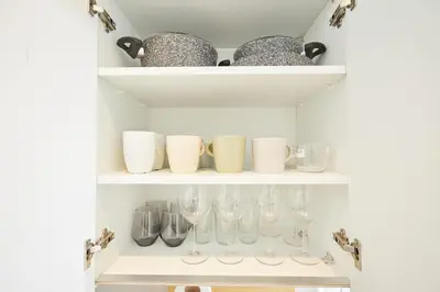 a shelf with wine glasses and bowls on it at Charming 3BR 2Bath AC in Center - Santur D8 in Istanbul