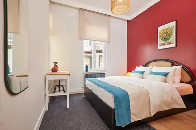 a bedroom with a red wall and a bed at Charming 3BR 2Bath AC in Center - Santur D8 in Istanbul