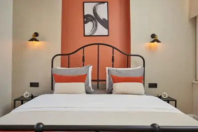 a bedroom with a large bed with an orange wall at Spacious 3BR 2Bath AC in Center - Santur D9 in Istanbul