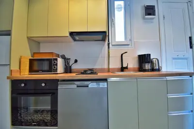 a kitchen with white cabinets and a microwave at Cozy Renovated 3BR near Taksim- Santur D10 in Istanbul
