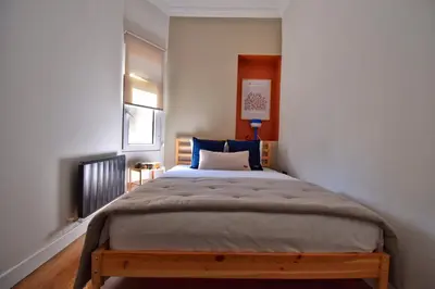 a bedroom with a large bed with blue pillows at Cozy Renovated 3BR near Taksim- Santur D10 in Istanbul