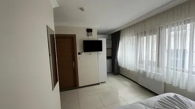 a room with a television and a room with a bed at The balo pera hotel in Istanbul