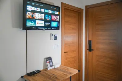 a flat screen tv on a wall next to a door at The balo pera hotel in Istanbul