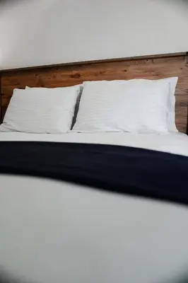 a bed with white sheets and pillows on it at The balo pera hotel in Istanbul