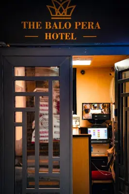a door to a hotel with a sign on it at The balo pera hotel in Istanbul