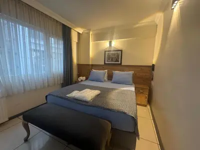 a small bedroom with a bed and a window at The balo pera hotel in Istanbul