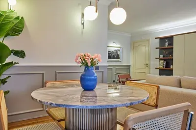 a blue vase with flowers on a table in a living room at Stunning Apartment in Bebek - Manolya8 in Istanbul
