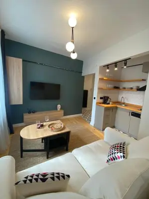 a living room with a white couch and a table at Stunning Apartment Near Metro - Değirmen 64 in Istanbul