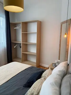a bedroom with a bed and a book shelf at Stunning Apartment Near Metro - Değirmen 64 in Istanbul