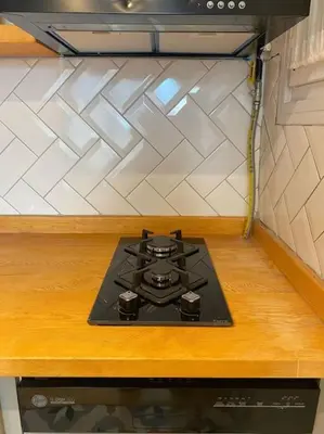 a stove top in a kitchen with a counter top at Stunning Apartment Near Metro - Değirmen 64 in Istanbul