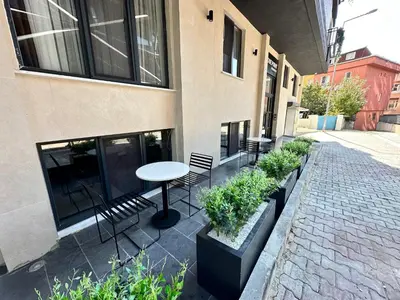 a patio with a table and chairs and plants at Rose Point Residence in Istanbul