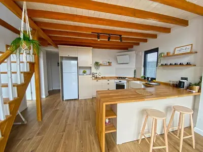 a kitchen with a counter and two bar stools at Sapanca İnci Suit in Yanık