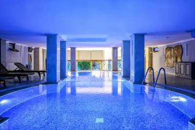 a large swimming pool in a building with blue lighting at Boğaz Manzaralı Havuzlu Lüks Villa in Istanbul