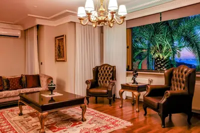 a living room with a couch and chairs and a chandelier at Boğaz Manzaralı Havuzlu Lüks Villa in Istanbul