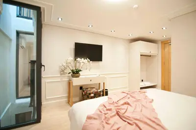 a bedroom with a bed and a tv on the wall at XLoft in Istanbul