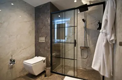 a bathroom with a toilet and a glass shower at XLoft in Istanbul