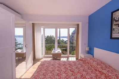 a bedroom with a large bed and a large window at Contemporary Waterfront Apt with a Stunning View in Istanbul