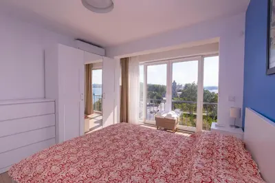 a bedroom with a bed and a large window at Contemporary Waterfront Apt with a Stunning View in Istanbul