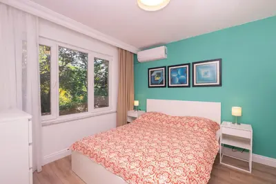 a bedroom with a bed and two windows at Contemporary Waterfront Apt with a Stunning View in Istanbul