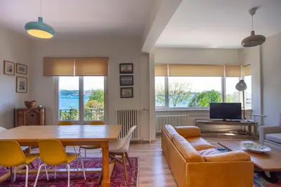 a living room with a table and a couch at Waterfront Apartments with a Stunning View in Istanbul