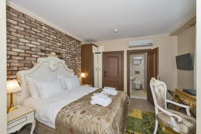 a hotel room with a bed with towels on it at By Murat Royal Hotel Galata in Istanbul