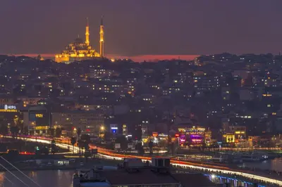 a city lit up at night with a city at By Murat Royal Hotel Galata in Istanbul