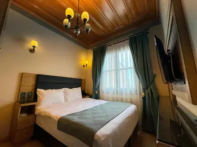 a small bedroom with a bed and a window at Abelia Mansion Hotel in Istanbul