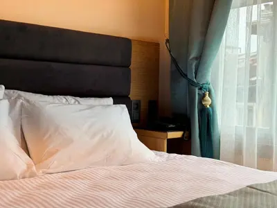 a bedroom with a bed with a window and a pillow at Abelia Mansion Hotel in Istanbul